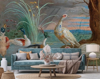May include: A teal blue sofa with a throw blanket and pillows in front of a wall mural featuring a white bird, two ducks, and a green plant.