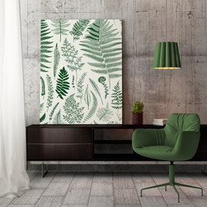 Puede incluir: Un sillón verde con un armario de madera marrón oscuro y una impresión enmarcada de helechos verdes sobre un fondo blanco. La impresión está colgada en una pared de hormigón.