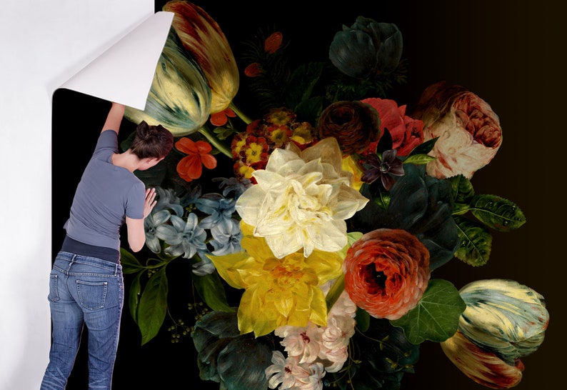 May include: A close-up of a floral arrangement featuring a variety of flowers, including tulips, roses, and lilies. The flowers are arranged in a vase and are set against a dark background.