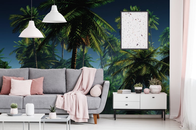May include: A living room interior with a gray sofa, a white coffee table, and a white dresser. The wall is decorated with a tropical palm tree mural.