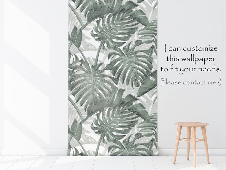 May include: A white wall with a green and white tropical leaf wallpaper. A wooden stool is in the foreground. The text "I can customize this wallpaper to fit your needs. Please contact me. :)" is on the wall.