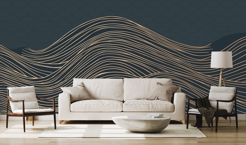 May include: A living room interior design with a white sofa and two chairs, a white coffee table, and a floor lamp. The wall behind the furniture is decorated with a dark blue wallpaper with a pattern of gold wavy lines.