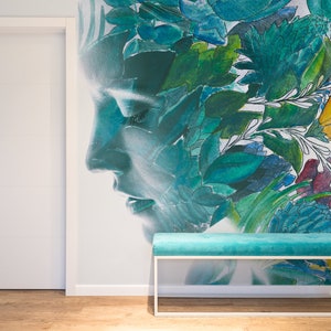 May include: A teal bench with a white metal frame sits in front of a wall mural. The mural features a woman's profile overlaid with colorful floral and leaf designs in shades of green, blue, yellow, and red. A white door is on the left.