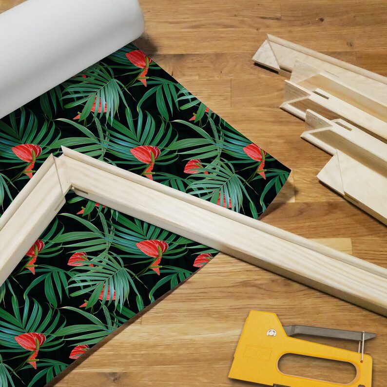 Puede incluir: Un marco de lienzo de madera con un patr&oacute;n de hojas y flores tropicales impreso en lienzo. Tambi&eacute;n se puede ver una grapadora en la imagen.