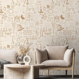 May include: A beige wallpaper with a repeating pattern of brown illustrations. The illustrations include a variety of symbols, such as a scale, a compass, a book, a vial, a moth, a crescent moon, a sun, a key, a feather, a plant, a candle, a bat, a pair of scissors, an hourglass, and a skull. The text "In this time and in this place Take the earth spirit I implore Bring it forth while I go back I inhabit a world of black" is repeated throughout the pattern.