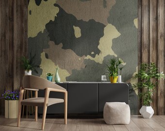 May include: A living room with a black cabinet, a brown chair, a white ottoman, and a wall with a camouflage pattern. There are plants in pots on the floor and a small clock on the cabinet.