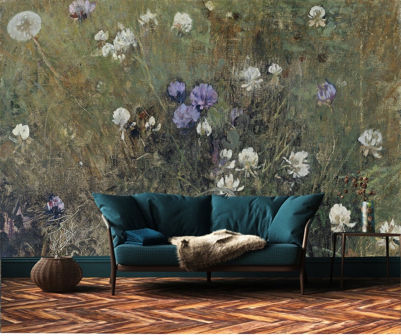 May include: A teal blue sofa with a faux fur throw blanket in front of a wall mural depicting a field of white and purple flowers.