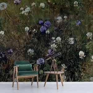May include: A green velvet armchair with wooden legs sits in front of a wall mural depicting a field of white and purple wildflowers. A small wooden table with a telescope on top sits in front of the chair.