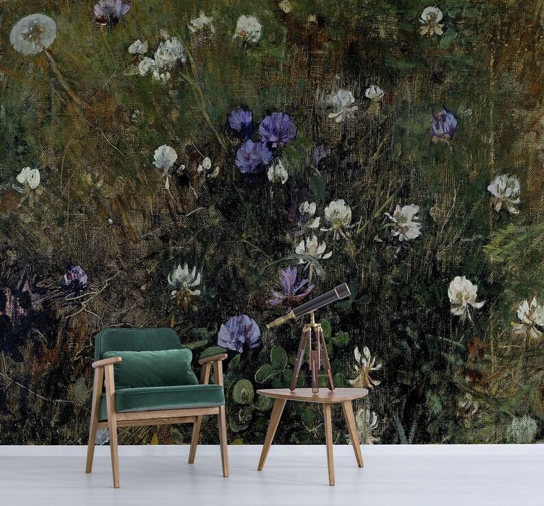 May include: A green velvet armchair with wooden legs sits in front of a wall mural depicting a field of white and purple wildflowers. A small wooden table with a telescope on top sits in front of the chair.