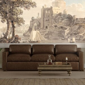 May include: A brown leather sofa with a wooden coffee table in front of it. The wall behind the sofa has a watercolor mural depicting a castle and a river with sailboats.