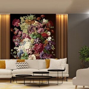 May include: A living room interior design with a white sectional sofa, three black coffee tables, a white armchair, and a large floral print on the wall.