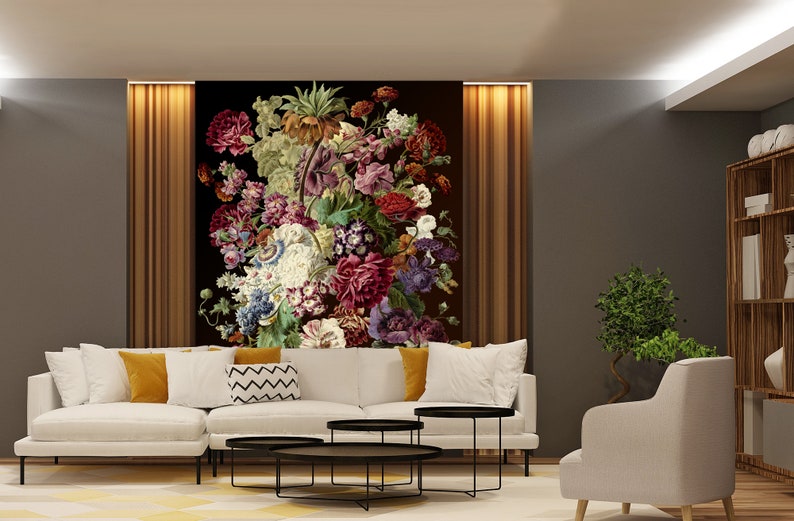 May include: A living room interior design with a white sectional sofa, three black coffee tables, a white armchair, and a large floral print on the wall.