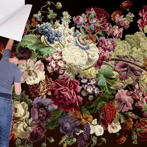 May include: A close-up of a floral wallpaper with a variety of flowers in shades of red, pink, purple, white, and green. The flowers are arranged in a bouquet and are set against a dark background.