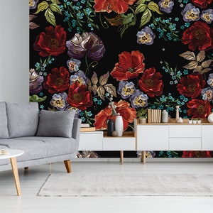May include: A black background with a floral pattern featuring red, purple, and blue embroidered flowers. The flowers are arranged in a repeating pattern and are surrounded by green leaves.