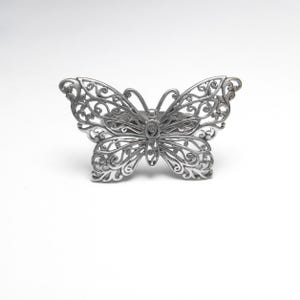 Op de afbeelding: Een set van drie keramische mokken met een gespikkelde, matte afwerking. De mokken zijn in de tinten crème, lichtgrijs en donkergrijs. Elke mok heeft een eenvoudig, minimalistisch ontwerp, perfect voor koffie of thee.