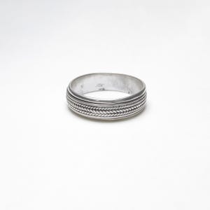 May include: A silver ring with a braided design. The ring is simple and elegant.