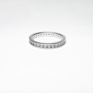 May include: A silver band ring with a row of small diamonds set in the band.