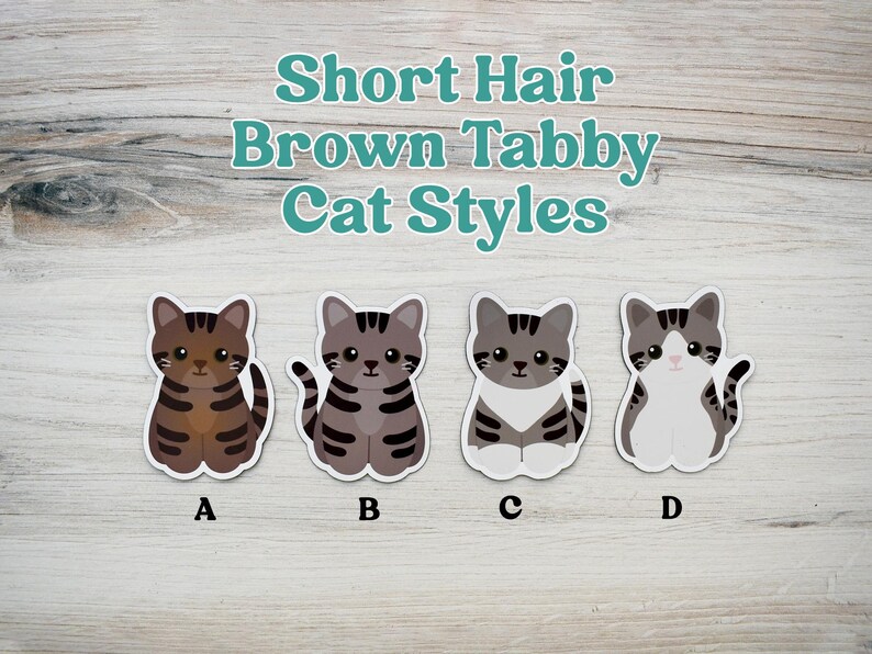 May include: Four illustrated stickers of short hair brown tabby cats labeled A, B, C, and D. The text Short Hair Brown Tabby Cat Styles is displayed above the cats. Each cat features distinct brown and gray striped patterns and white markings.