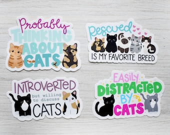 May include: Four cat-themed stickers with colorful text and illustrations. The stickers feature phrases like "Probably Thinking About Cats", "Rescued is My Favorite Breed", "Introverted but Willing to Discuss Cats", and "Easily Distracted by Cats".