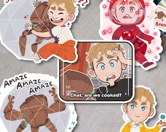 May include: A collection of five die-cut stickers featuring a cartoon character with blonde hair. Designs include the character hugging a brown rock creature, wearing a red NASA spacesuit, holding a small planet, and a rectangular sticker with the text Chat, are we cooked? and a rock creature with the text AMAZE AMAZE AMAZE.