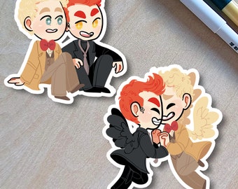 May include: Two cartoon stickers featuring a pair of characters with red and blonde hair. The first sticker shows the characters standing side-by-side, one wearing a brown suit and the other wearing a black suit. The second sticker shows the characters embracing, one with angel wings and the other with devil wings.