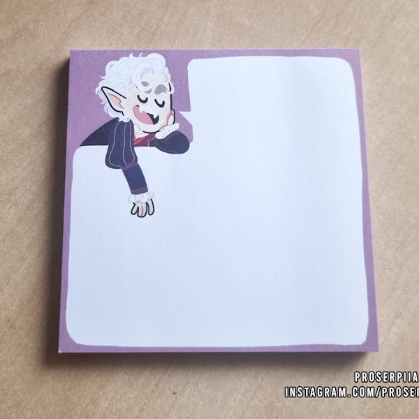 May include: A purple sticky note with a cartoon illustration of a white-haired vampire with a black coat and a white shirt. The vampire is looking to the right and has a surprised expression. The note has a white background and a purple border.