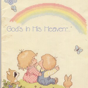May include: A cross-stitch pattern featuring two children looking up at a rainbow with the text "God's In His Heaven..."