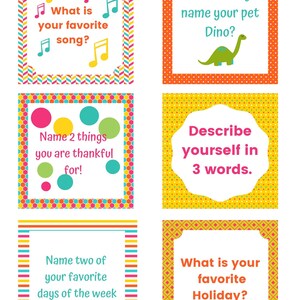 May include: A set of colorful cards with prompts for a game. The cards have different colored borders and patterns. The prompts include questions like "What is your favorite song?" and "What would you name your pet Dino?"