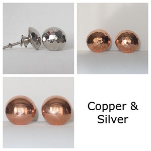May include: Two sets of hammered metal knobs, one set in copper and one set in silver.  Copper & Silver.
