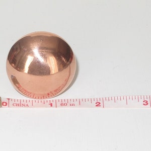 May include: A shiny copper sphere measuring 1 inch in diameter.