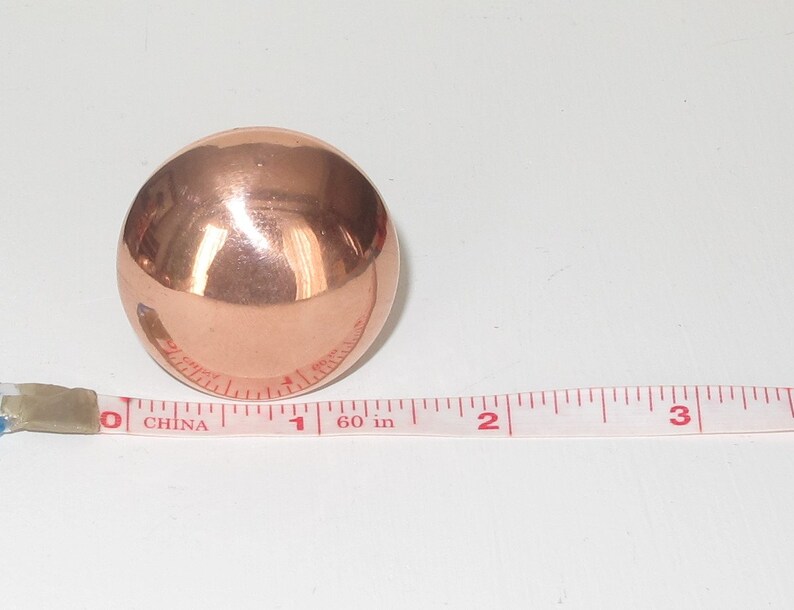 May include: A shiny copper sphere measuring 1 inch in diameter.