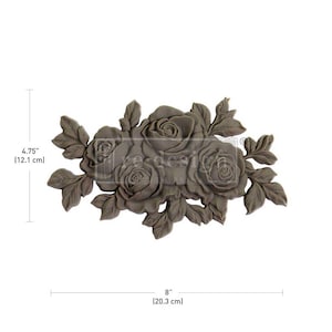 May include: A decorative, grey, floral motif with five roses and leaves. The motif measures 12.1 cm tall and 20.3 cm wide.