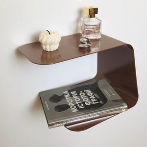 May include: A set of three ceramic mugs with a speckled, matte finish. The mugs are in shades of cream, light gray, and dark gray. Each mug has a simple, minimalist design, perfect for coffee or tea.