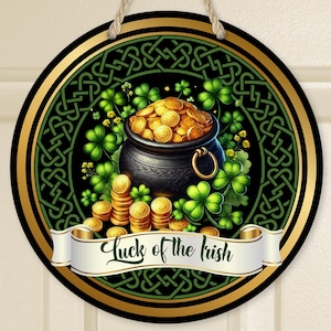 May include: Round wooden door sign featuring a black pot overflowing with gold coins, surrounded by green shamrocks and Celtic knotwork. A white banner displays the text "Luck of the Irish". The sign is trimmed with gold and black.