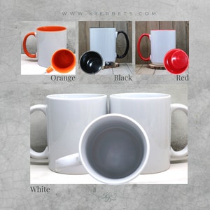 May include: Four ceramic mugs with different colored rims. The mugs are white with a black rim, orange rim, red rim, and a white rim. The mugs are all the same size and shape.