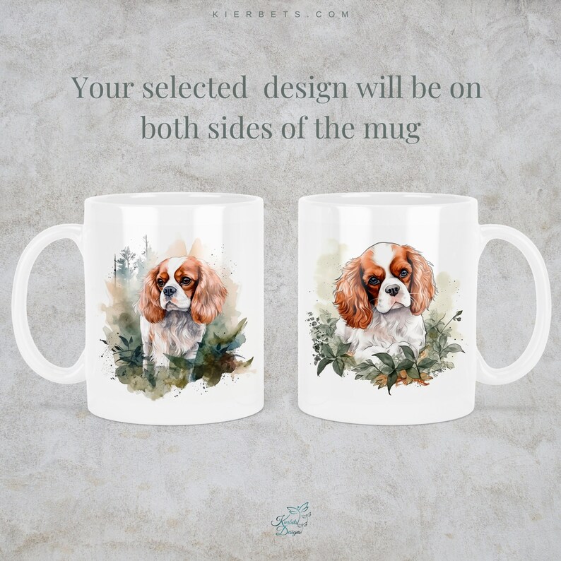 May include: White ceramic mug with a watercolor illustration of a Cavalier King Charles Spaniel dog on both sides. The dog is brown and white with a green leafy background.