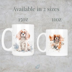 May include: Two white ceramic mugs with watercolor illustrations of a Cavalier King Charles Spaniel dog. The mug on the left shows the dog sitting and the mug on the right shows the dog running. The text "Available in 2 sizes" is at the top of the image. The text "15oz" is below the left mug and the text "11oz" is below the right mug.