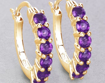 May include: Gold hoop earrings with a row of purple amethyst gemstones.