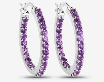 May include: Silver hoop earrings with a row of purple amethyst gemstones around the entire hoop.