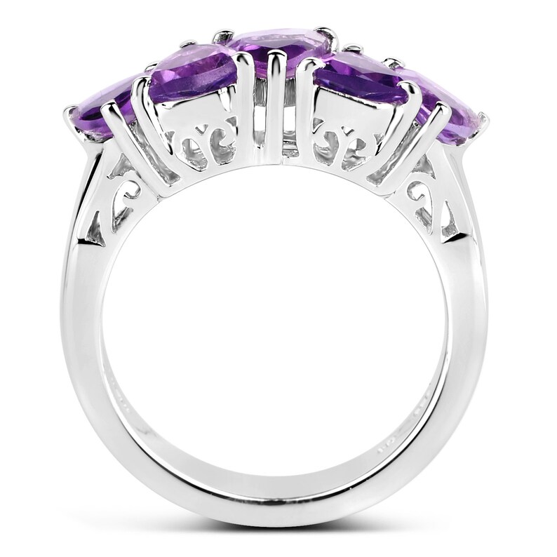 May include: A silver ring with four oval-shaped amethyst gemstones set in a delicate filigree design.