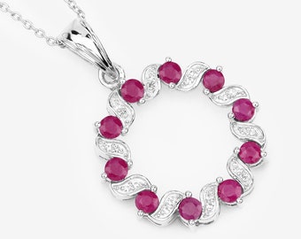 May include: A silver necklace with a pendant featuring a circle of red rubies and white diamonds.
