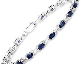 May include: A silver bracelet with a chain design and oval-shaped blue sapphires.