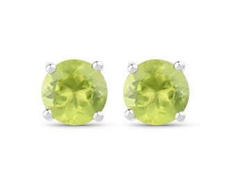 May include: A pair of silver stud earrings with round, green peridot gemstones.