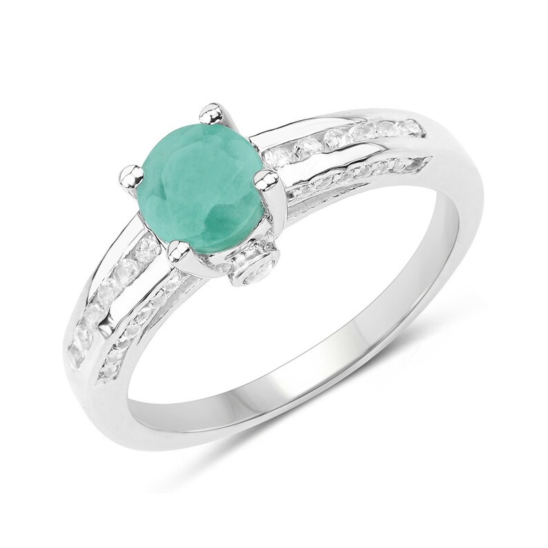 May include: A silver ring with a round, light green gemstone surrounded by a row of smaller, clear gemstones.