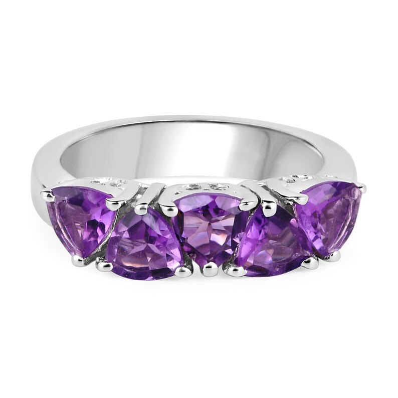 May include: A silver ring with four amethyst gemstones set in a triangular shape. The ring is made of sterling silver and features a polished finish.