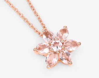 May include: A delicate rose gold necklace with a pendant shaped like a flower. The flower is made of multiple oval-shaped pink gemstones.