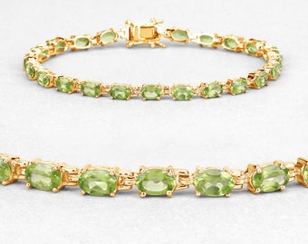 May include: A gold chain bracelet with oval-shaped green peridot gemstones.