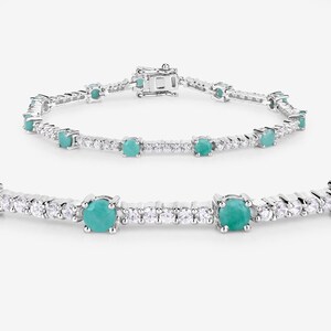 May include: A silver tennis bracelet featuring round turquoise gemstones and smaller clear gemstones.