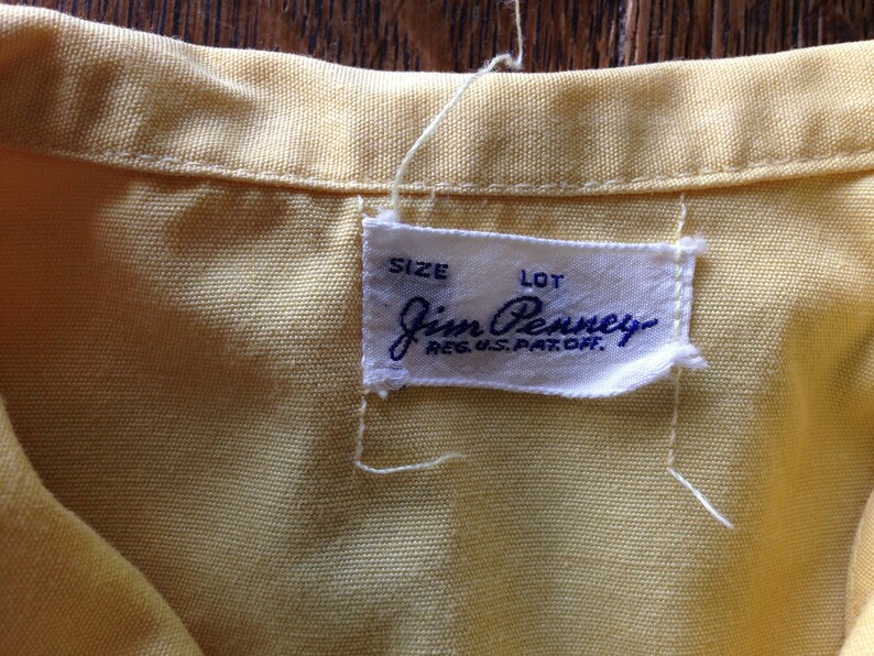 May include: A white tag with blue text that reads "J.C. Penney Reg. U.S. Pat. Off." with the words "Size" and "Lot" above the company name.