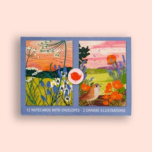 May include: A box of notecards with envelopes featuring two illustrations of a sunset over a field with flowers and birds. The box is blue with the text "12 notecards with envelopes - 2 Onneke illustrations."